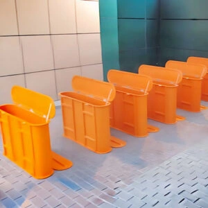 Bright orange GRP barrier units for construction site safety and storage
