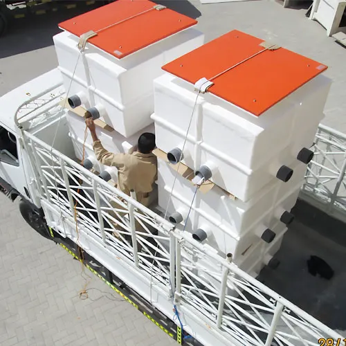 GRP fiberglass tanks being transported with multi outlet pipe connections